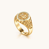 Angled product view of the yellow gold Reversible Dojang Ring, showing the raised circular seal face, intricate floral openwork along the shoulders, and NUNCHI engraving inside the band.